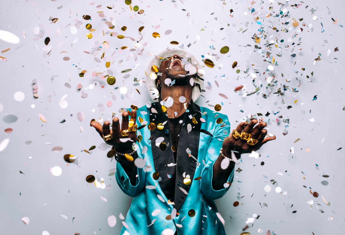 man-celebrates-with-confetti-in-turquoise-blazer-2026-03-24-03-32-44-utc