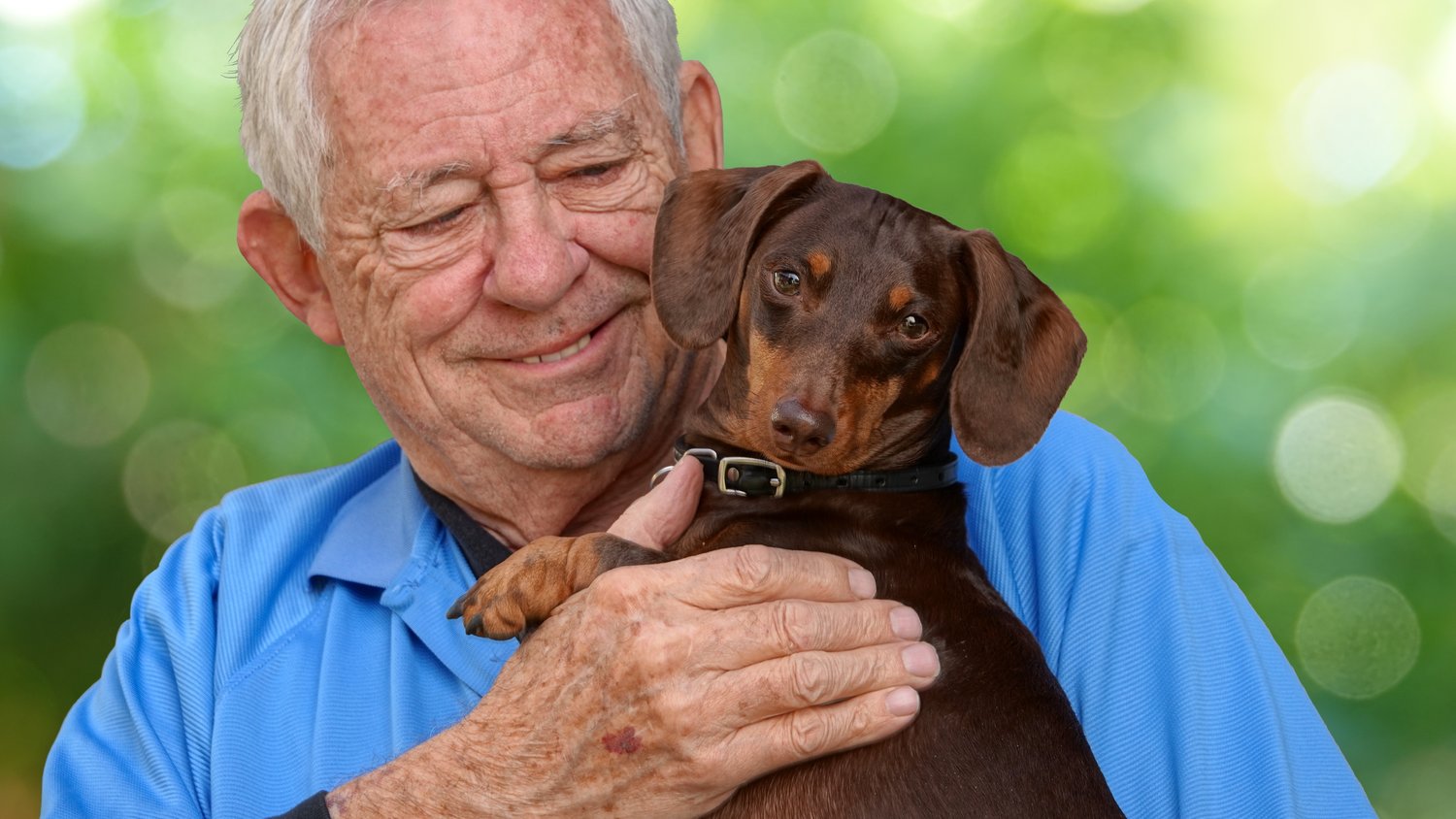 senior-man-cuddling-brown-dachshund-dog-outside-2026-03-18-07-04-41-utc senior-man-cuddling-brown-dachshund-dog-outside-2026-03-18-07-04-41-utc